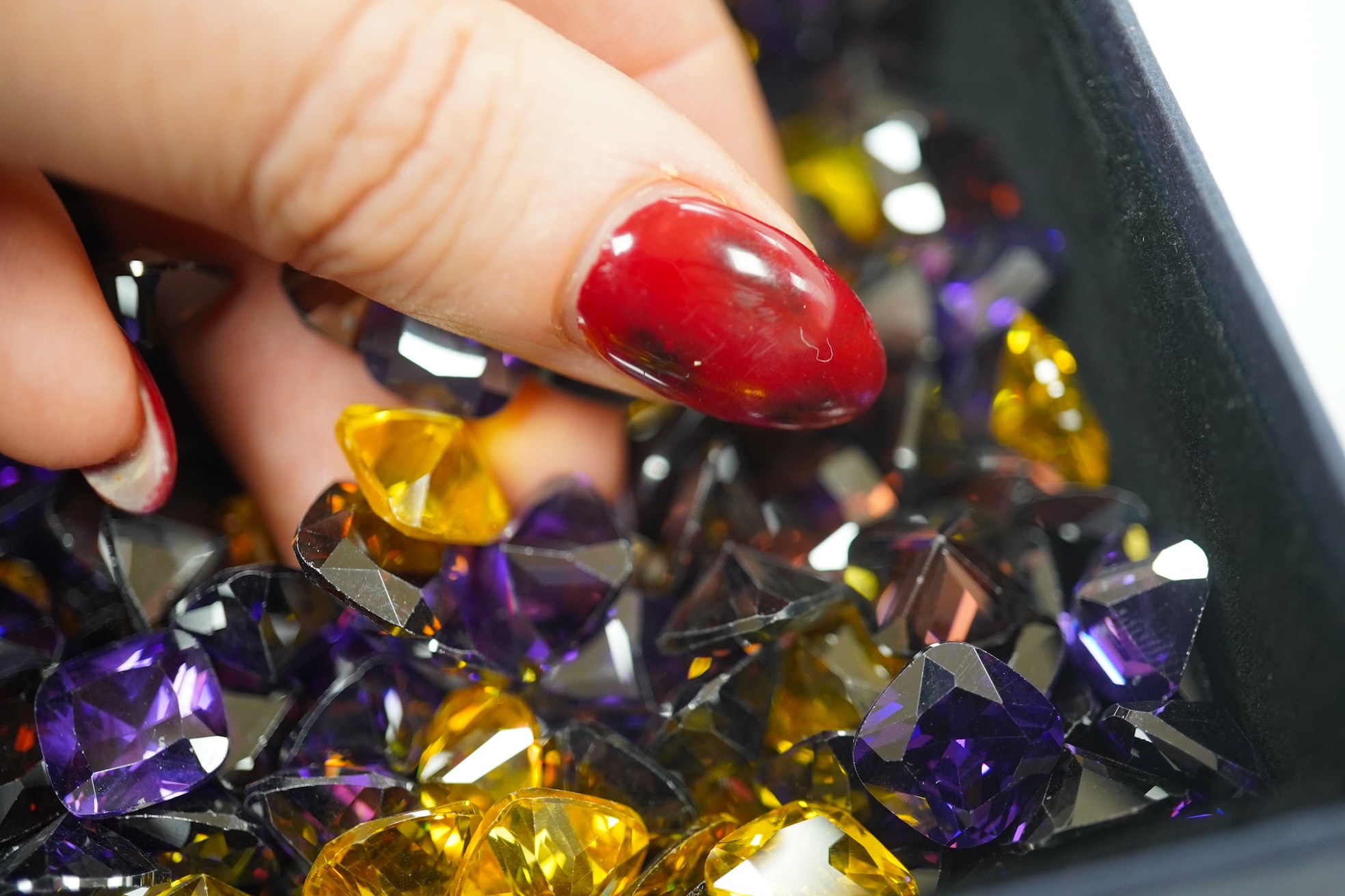 A quantity of assorted cut coloured cubic zirconia stones. Condition - poor to fair to good